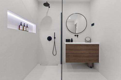 a white bathroom with a sink and a mirror at Casa Calme luxury villa surounded with nature Opatija including EVcharging station in Opatija
