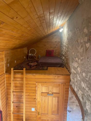 a small room with a bed in a wooden cabin at Nadiza Hilltop Retreat in Breginj