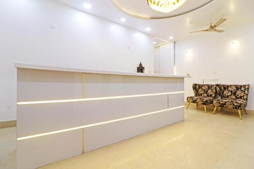 a room with a counter and a chair in it at Frankstay By Hotel Samrat Residency 10 Mints Walking Distance Nizamuddin Railway Station in New Delhi