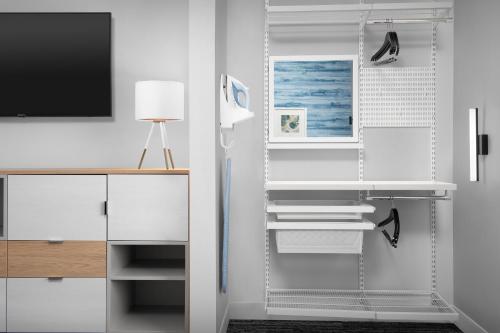 a white room with a desk and a tv at TownePlace Suites By Marriott Lake City in Lake City