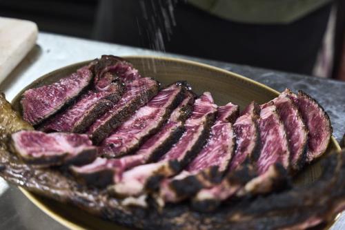 a bunch of meat in a bowl on a table at La Flambée in Sennecey-lès-Dijon