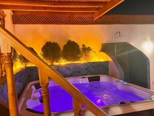 a jacuzzi tub in a house with a staircase at Riad Madinina in Marrakech