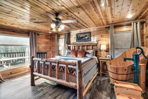 a log cabin bedroom with a bed and a ceiling fan at 8 Beds, Hot Tub, Fireplaces, Pool Tbl Arcade VIEWS! in Sevierville