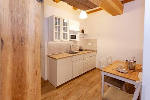 a kitchen with a sink and a table with a tablektop at Resort Mlýn Karolínka in Vranov nad Dyjí