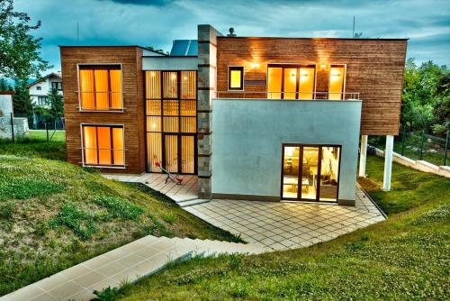 a house with lights on in front of it at Holiday Home Marta in Dobrevtsi