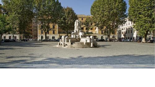 a statue sitting in the middle of a street at Testaccio Stay - your home in the heart of Rome in Rome