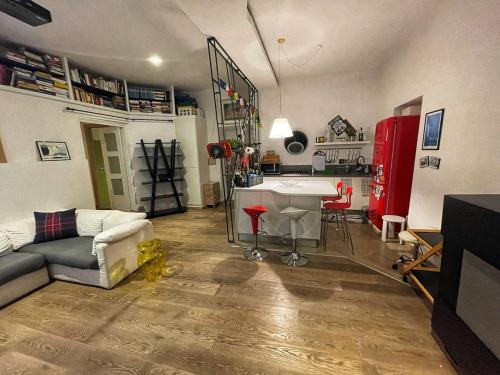a living room with a couch a table and a kitchen at Testaccio Stay - your home in the heart of Rome in Rome