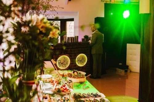 a man standing in front of a table with food at Hotel & Restauracja Timberland in Orzesze