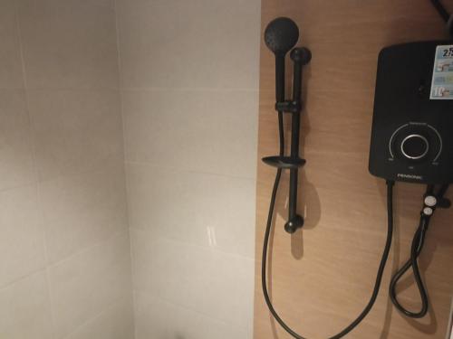 a hair dryer is attached to a wall at Keteri Boutique Hotel in Kangar