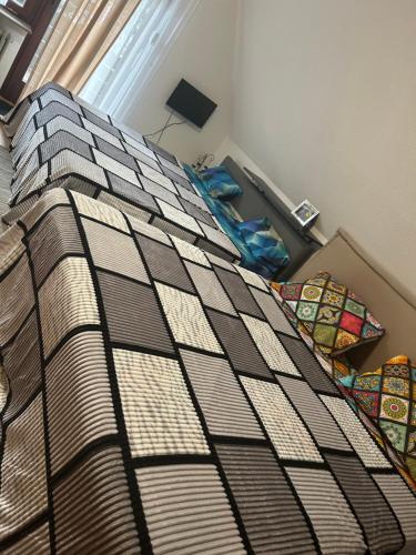 a bedroom with a bed with a comforter on it at Jacky Apartment in Schonwald im Schwarzwald