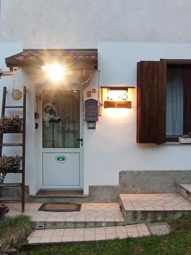 a white house with a door with a window at Casa Valletta in Mezzomerico