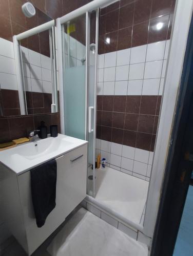 une salle de bain avec douche et lavabo dans l'établissement le calme, à Bourges