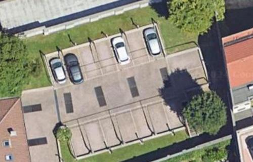 an overhead view of a building with two cars on it at Harmony Navigli Apartment in Milan