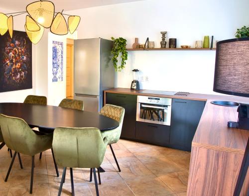 a kitchen with a table and chairs in a room at Abondante Paradise in Jan Thiel