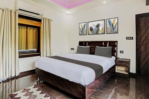 a bedroom with a large bed in a room at Hotel O S.N Sky Awadh in Lucknow