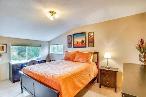 a bedroom with a bed with an orange bedspread at Sequoia Vacation Rental in Milton