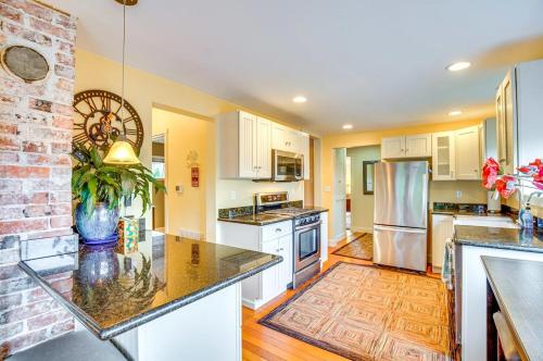 a kitchen with white cabinets and a brick wall at Sequoia Vacation Rental in Milton