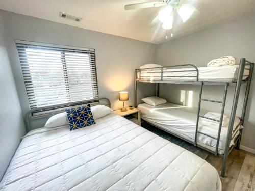 a bedroom with two bunk beds and a window at Modern Condo Central Huron Boat Basin Area in Huron