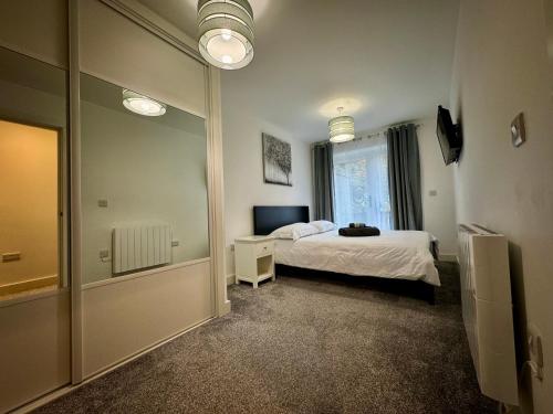 a bedroom with a bed and a large mirror at Seafarers Stays in Southampton