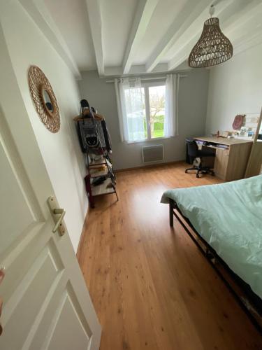 a bedroom with a bed and a desk in a room at Maison - Ustaritz - proche Biarritz in Ustaritz