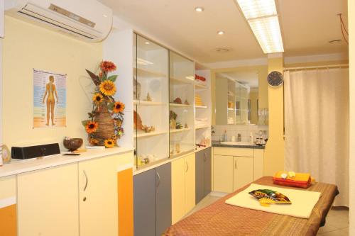 a kitchen with white cabinets and a table in it at Farbinger Hof in Bernau am Chiemsee