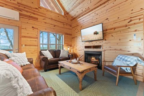 a living room with a fireplace and a tv at Cabin 4 Mtn View Cabin Near River with Fire Pit and Hot Tub in Jasper