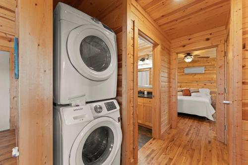 a bathroom with a washer and dryer in a cabin at Cabin 4 Mtn View Cabin Near River with Fire Pit and Hot Tub in Jasper
