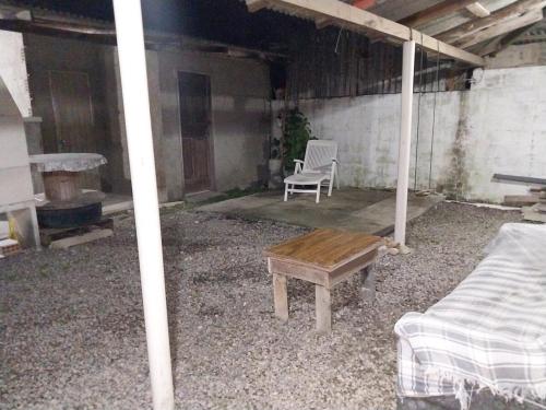 a room with a table and a bench and a chair at Casa na praia do sonho in Palhoça