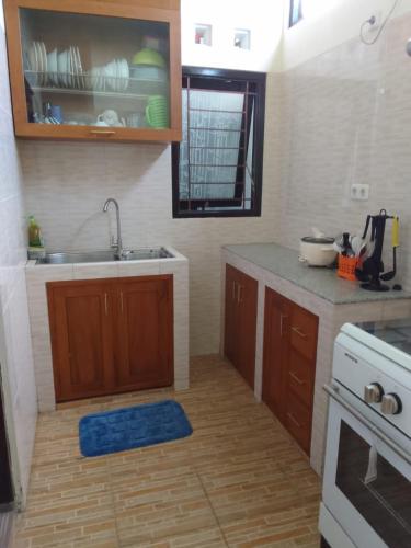 a kitchen with a sink and a counter top at Royal Stay@Yogyakarta in Kalasan