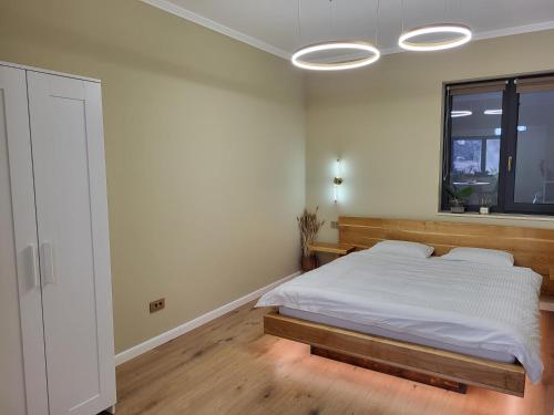a bedroom with a bed and a window at Ophir Apartment Central in Cluj-Napoca