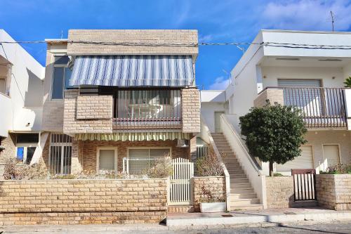 a brick house with a staircase in front of it at Nido del Mar in Lendinuso