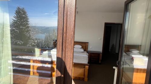 a room with a view of a balcony with two beds at Lac Colibita in Colibiţa