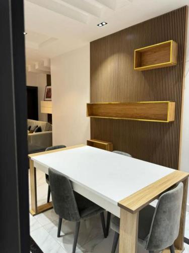 a white table and chairs in a room at Ayahs Court in Abuja