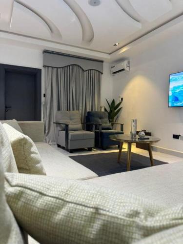a living room with a couch and a table at Ayahs Court in Abuja