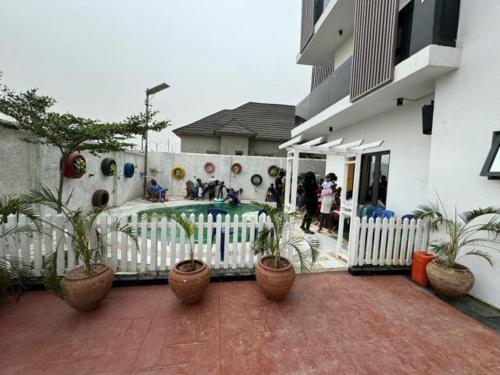 a courtyard with potted plants in front of a building at Ayahs Court in Abuja