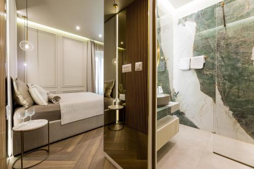 a small bathroom with a bed and a shower at K&K2 Luxury Studios in Split