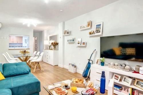 een woonkamer met een blauwe bank en een tafel bij Comfortable house in Fuengirola with terrace in Fuengirola