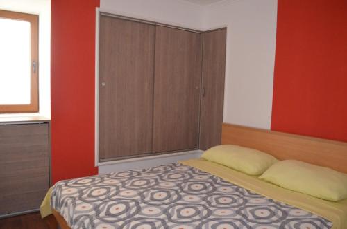 a bedroom with a bed with a cabinet at Apartment Željko in Baška