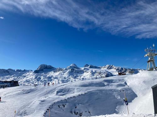 a group of people skiing down a snow covered mountain at Apartment Elisabeth in Obertraun