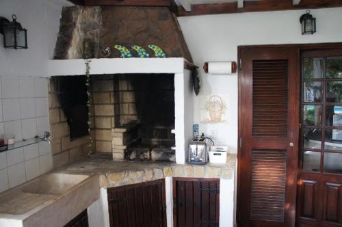 a kitchen with a sink and a stone counter top at João Jungle in Açafora