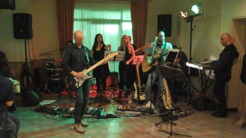 a group of people playing music in a room at Hotel Genius in Corato