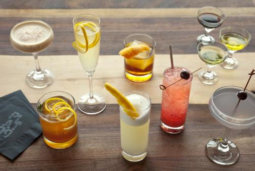 a group of different types of drinks on a table at The Alexander in Indianapolis