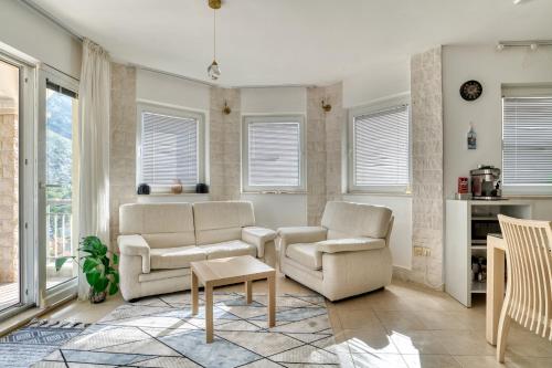 a living room with two chairs and a table at Kotor Vista Seaview apartment by MN Property in Muo