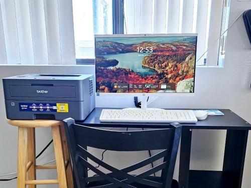 a desk with a computer and a monitor and a keyboard at Budgetel inn & Suites in Fort Scott