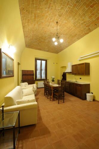 a living room with a couch and a table at Palazzo Centro Alloggi Vacanza in Nizza Monferrato