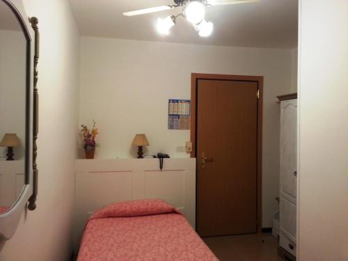 a bedroom with a bed and a ceiling fan at Dogana Vecchia - Hotel & Residence B&B Ristorante & Pizzeria in Trivignano Udinese