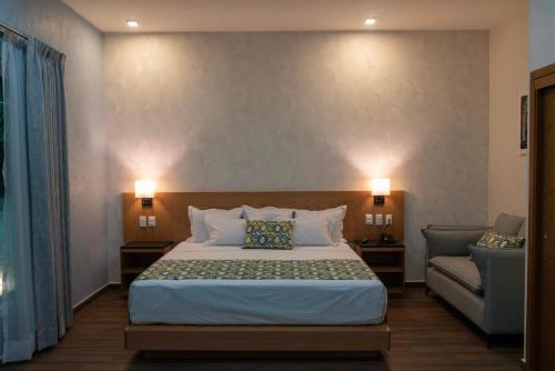 a hotel room with a bed and a couch at FCH Hotel Minerva-CAS in Guadalajara