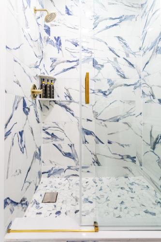 a bathroom with a shower with blue and white marble at Modern Escape 3BR Apt with Parking in New Rochelle