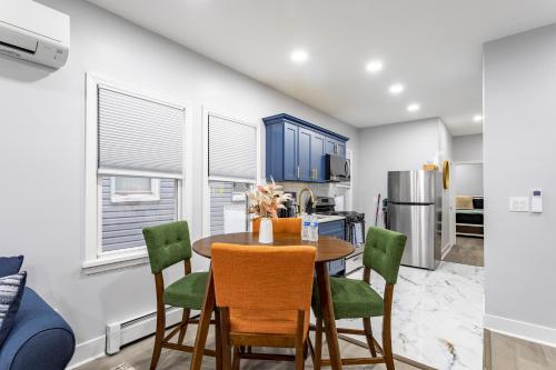 a kitchen and dining room with a table and chairs at Modern Escape 3BR Apt with Parking in New Rochelle