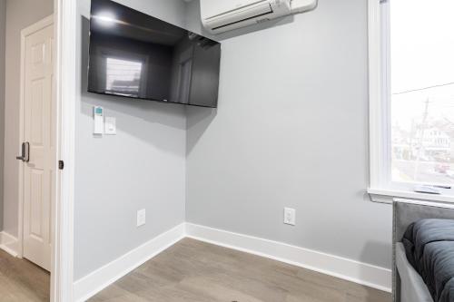 a room with a door with a microwave and a window at Comfort Meets Style 3BR Plus Parking in New Rochelle
